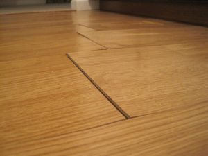 Hardwood floor pressed up due to structural damage